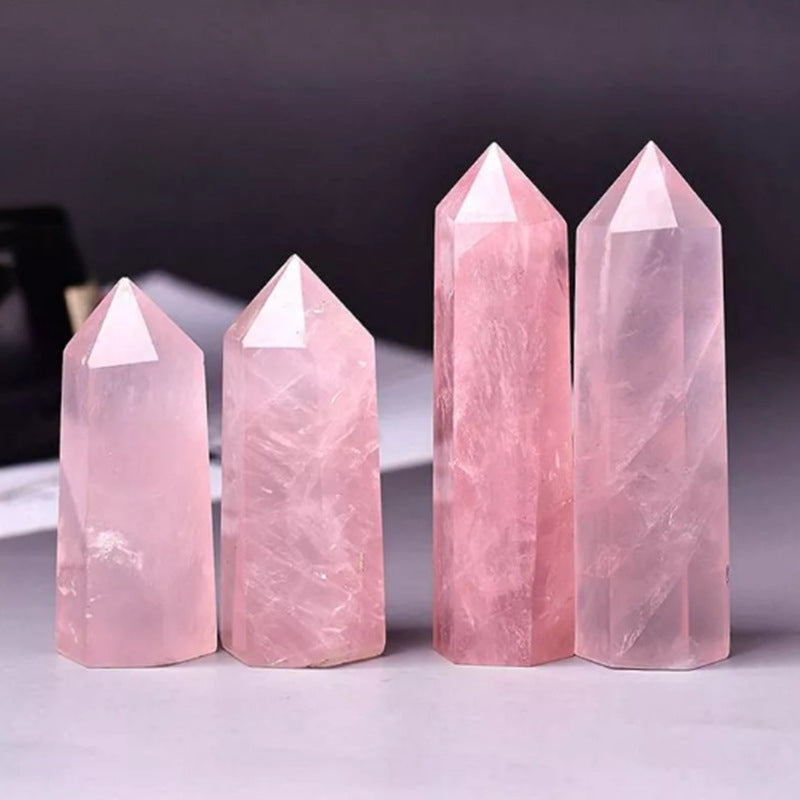 Natural single-terminated hexagonal Rose Quartz point isolated on white background showcasing crystal structure.
