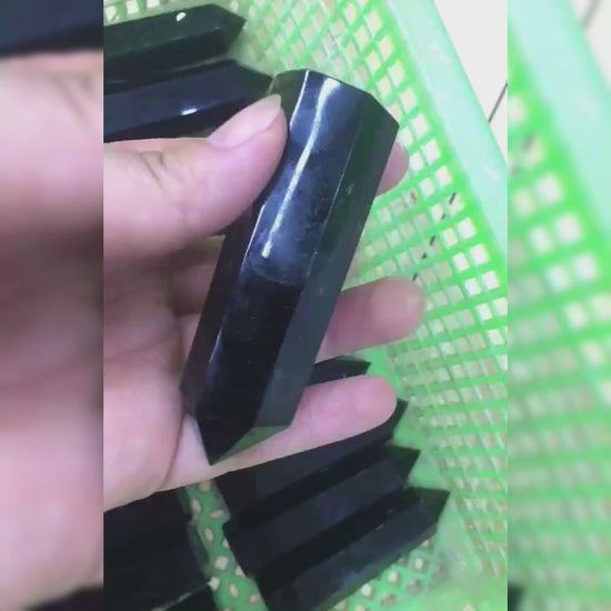 A video showing the natural beauty and uses of the black obsidian crystal point for meditation, home decor, and energy cleansing.