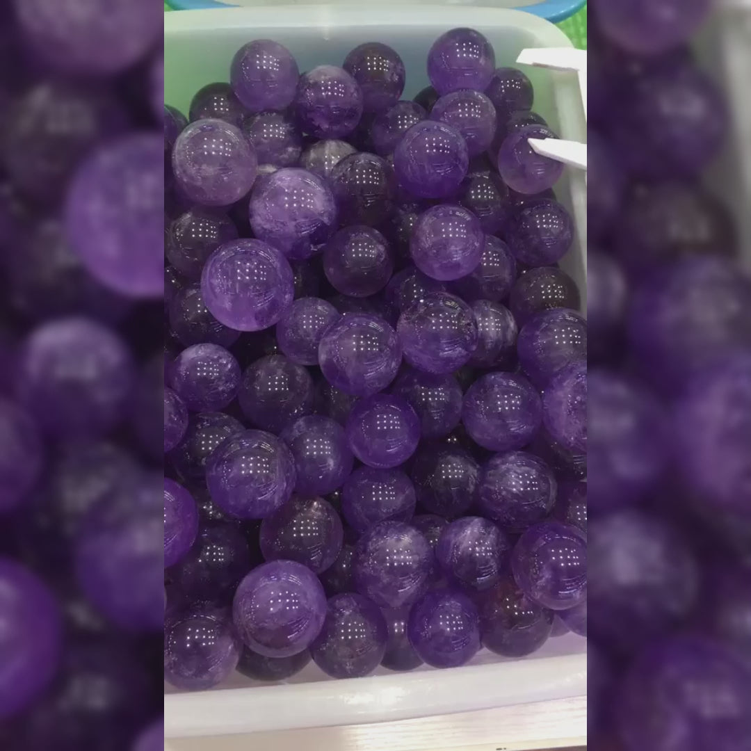 Watch how this genuine Brazilian amethyst sphere radiates calming purple energy for meditation and intuition. Perfect for desk decor, spiritual work, and energy cleansing. Elevate your space today!