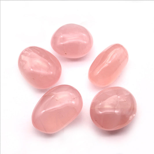 Natural raw rose quartz tumbled stones pink love healing crystals close-up