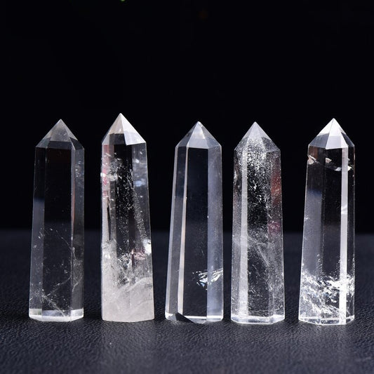 Natural single-terminated hexagonal Clear Quartz point isolated on white background, showcasing perfect geometric form.